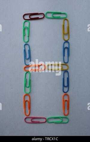 Number 8 made with colorful paper clips on white background Stock Photo