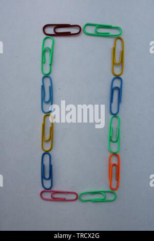 Number 0 made with colorful paper clips on white background Stock Photo