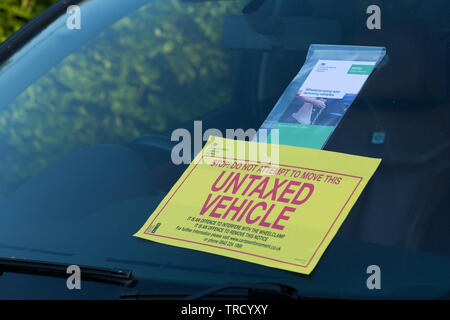 Cambridge Uk, 2019-May-14, Notice for vehicle owner not to attempt to drive away as vehicle had been wheel clamped due to being untaxed. Stock Photo