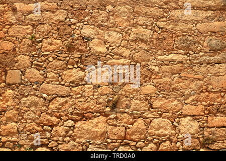 Big yellow wall made from stone bricks Stock Photo