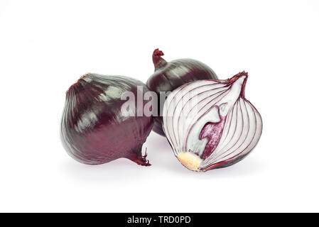 Red onion bulbs and one sliced half isolated on white background in close-up Stock Photo