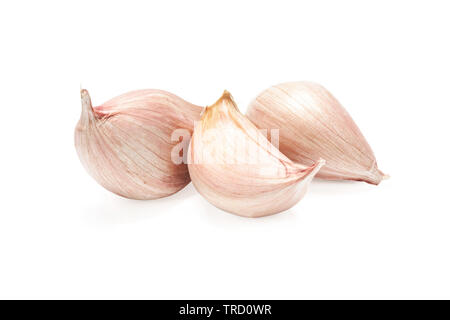 Three cloves of garlic isolated on a white background in close-up. Stock Photo