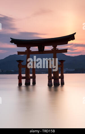 Miyajima island near Hiroshima, Japan - Silhouette of the  Itsukushima Floating Torii Gate at sunset Stock Photo