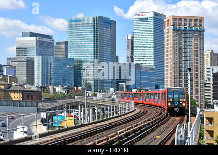 East London urban landscape inTower Hamlets with building development at Canary Wharf banking business offices & public passenger transport railway UK Stock Photo