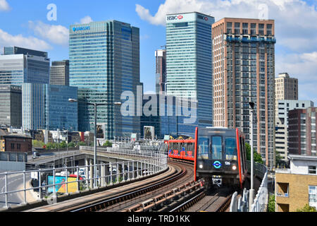 Tower Hamlets Canary Wharf Barclays Bank & HSBC banks building development on skyline East London Docklands DLR passenger train transport England UK Stock Photo