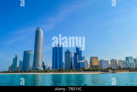 Abu Dhabi city skyline and skyscrapers along Corniche beach taken from a boat in UAE , United Arab Emirates Stock Photo