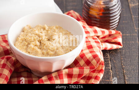 Plain Oatmeal on a Wooden Table with Red Checkered Table Cloth Stock Photo