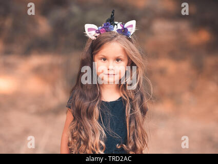 brunette headband unicorn kid healthy hair childhood stylish outdoors wearing looking portra camera summer alamy rf