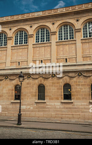 Old decorated building and lighting lamp on sidewalk and blue sky in Paris. One of the most impressive world’s cultural center in France. Stock Photo