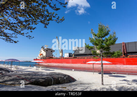 This huge red industrial ship blended in with the surroundings as if it was a part of urban planning. Stock Photo