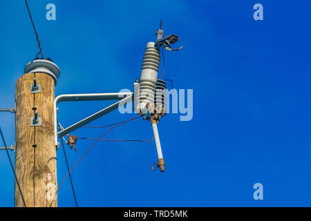 tripped line fuse on top of a telephone pole Stock Photo