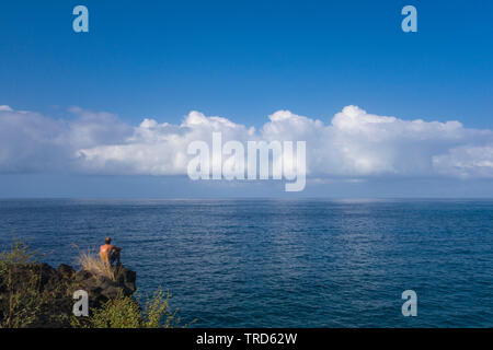 Solitary viewer at Alahaka Bay, Pu’uhonua o Honaunau National Park in Hawaii. Stock Photo