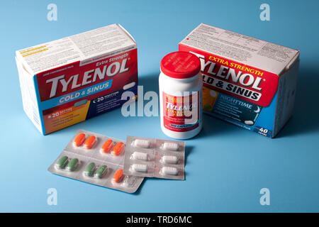 Halifax, Canada- May 31, 2019: Assorted Tylenol and Dayquil Nyquil cold medication against a blue backdrop Stock Photo