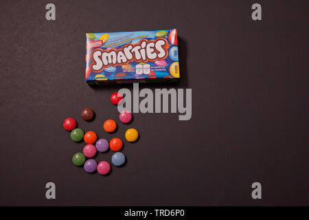 Halifax, Canada- May 31, 2019: Lay flat image of Nestle Smarties against black background Stock Photo