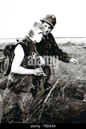 SS Sturmbannführer Franz Hack 5th SS Panzer Division Wiking comforts one of his severly wounded men on the Eastern Front 1944 PK SS KB Ernst Baumann Stock Photo