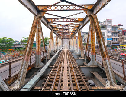Vintage railroad tracks leading over the famous Long Bien Bridge, Hanoi, Vietnam. This is the railway line was built so long and still in operation to Stock Photo