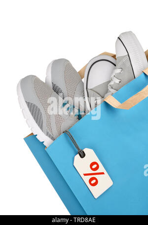 Shopping bag with sport shoes isolated on white background Stock Photo