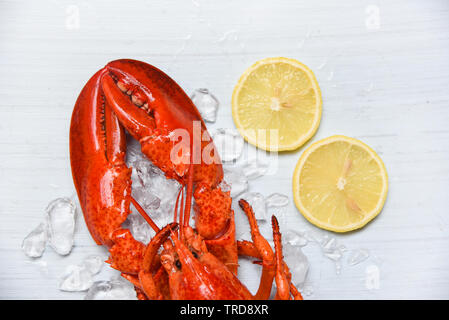 Lobster food on ice seafood shrimp with lemon on white wooden background on top view Stock Photo