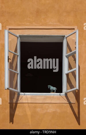Horse sculpture on a window sill Stock Photo