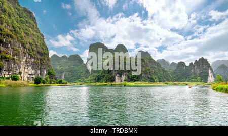 The scenic landscape of limestone mountains at Tam Coc National Park. Tam Coc is a popular tourist destination in Ninh Binh, Vietnam. Stock Photo