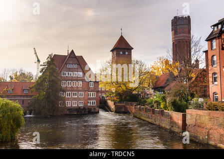 Ratsmuhle or old water mill and Wasserturm or water tower on Ilmenau river at morning in Luneburg. Germany Stock Photo