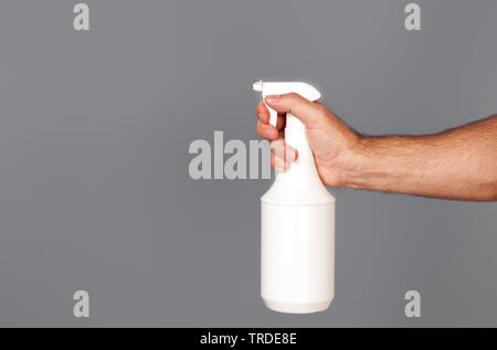hand holding spray bottle Stock Photo