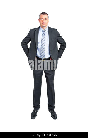 Portrait of a Businessman in a grey suit standing with hands in his hands on the hips Stock Photo