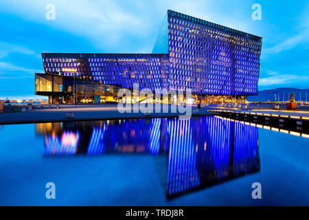 illuminated Harpa concert hall with distinctive colored glass facace in the evening, Iceland, Reykjavik Stock Photo