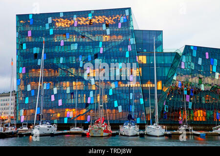 Harpa concert hall with distinctive colored glass facade and marina , Iceland, Reykjavik Stock Photo