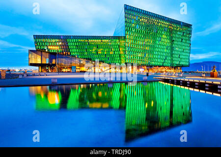 illuminated Harpa concert hall with distinctive colored glass facace in the evening, Iceland, Reykjavik Stock Photo