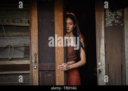 Woman Ghost drama standing on old door in wooden thai house / Horror Legend of Mae Nak Phra Khanong Stock Photo