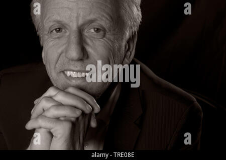Portrait of an middle aged man head resting on his hands (black and white photo) Stock Photo