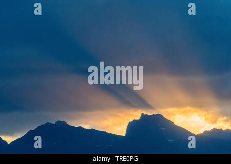 crepuscular rays over mount Hollendaren, Norway, Troms, Kvaloya Stock Photo