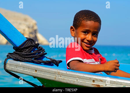 young fisher boy in a boat, Oman, Khasab Stock Photo