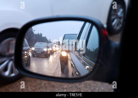 looking into the rear view mirror to the traffic jam on the motorway, Germany, Lower Saxony, Soltau Stock Photo