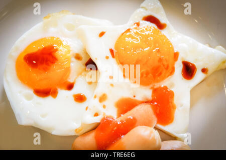 breakfast egg star shaped on plate and hot dog with sauce Stock Photo