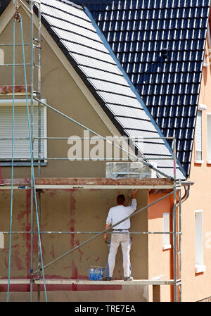 construction worker plastering the facade of an old building, Germany, North Rhine-Westphalia Stock Photo