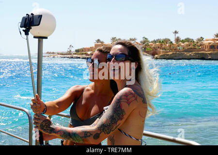 two young women taking selfies, Egypt, El Quseir Stock Photo