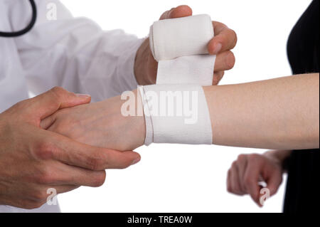 Close up of a doctor putting a bandage on female wrist Stock Photo