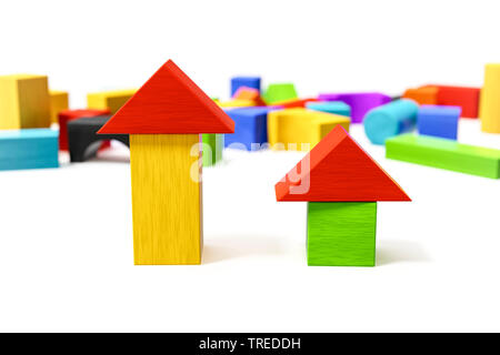 Two towers built out of multicolored wooden bricks, several more in the background Stock Photo