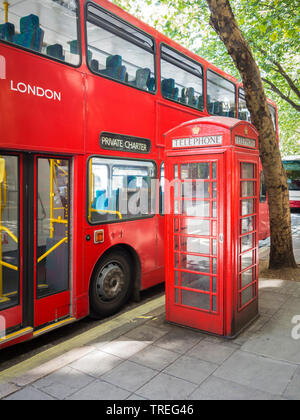 Double-decker bus next to a typical red telephone box, England, London