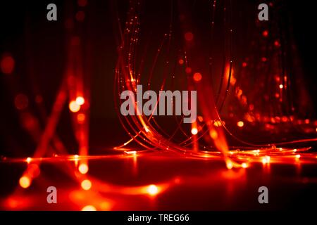 3D computer graphic, fieber optic cables light up in red color - light arts Stock Photo