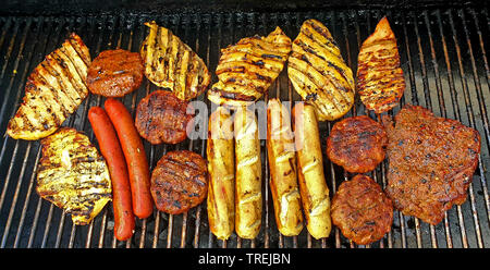 meat and sausages on a grill Stock Photo