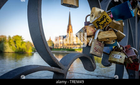 view on main and the gothic church dreikönigskirche from eiserner steg with wedding locks in foreground, Frankfurt germany Stock Photo