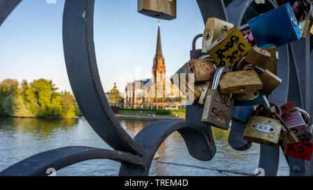 view on main and the gothic church dreikönigskirche from eiserner steg with wedding locks in foreground, Frankfurt germany Stock Photo