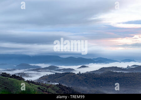 Magical cloud kissing hilltop at dawn from a flat angle Stock Photo
