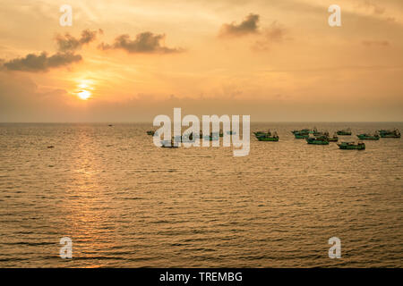Fishing boat heading towards the day to day fishing in the sunrise hours. Image taken from high angle showing the orange light of the sun and beautifu Stock Photo