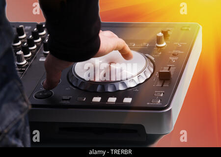 DJ hand controls the music panel Stock Photo