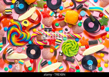 lollipops and candies on pink like background, top view Stock Photo