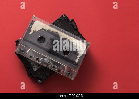 Audio cassette tape on red backgound, from above Stock Photo